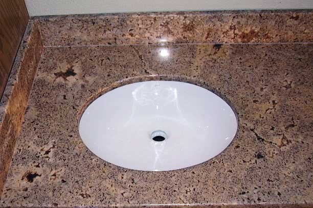 Washbasin hole cutting in black granite counter